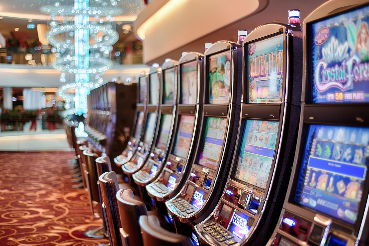 Player pressing the spin button on a casino slot machine