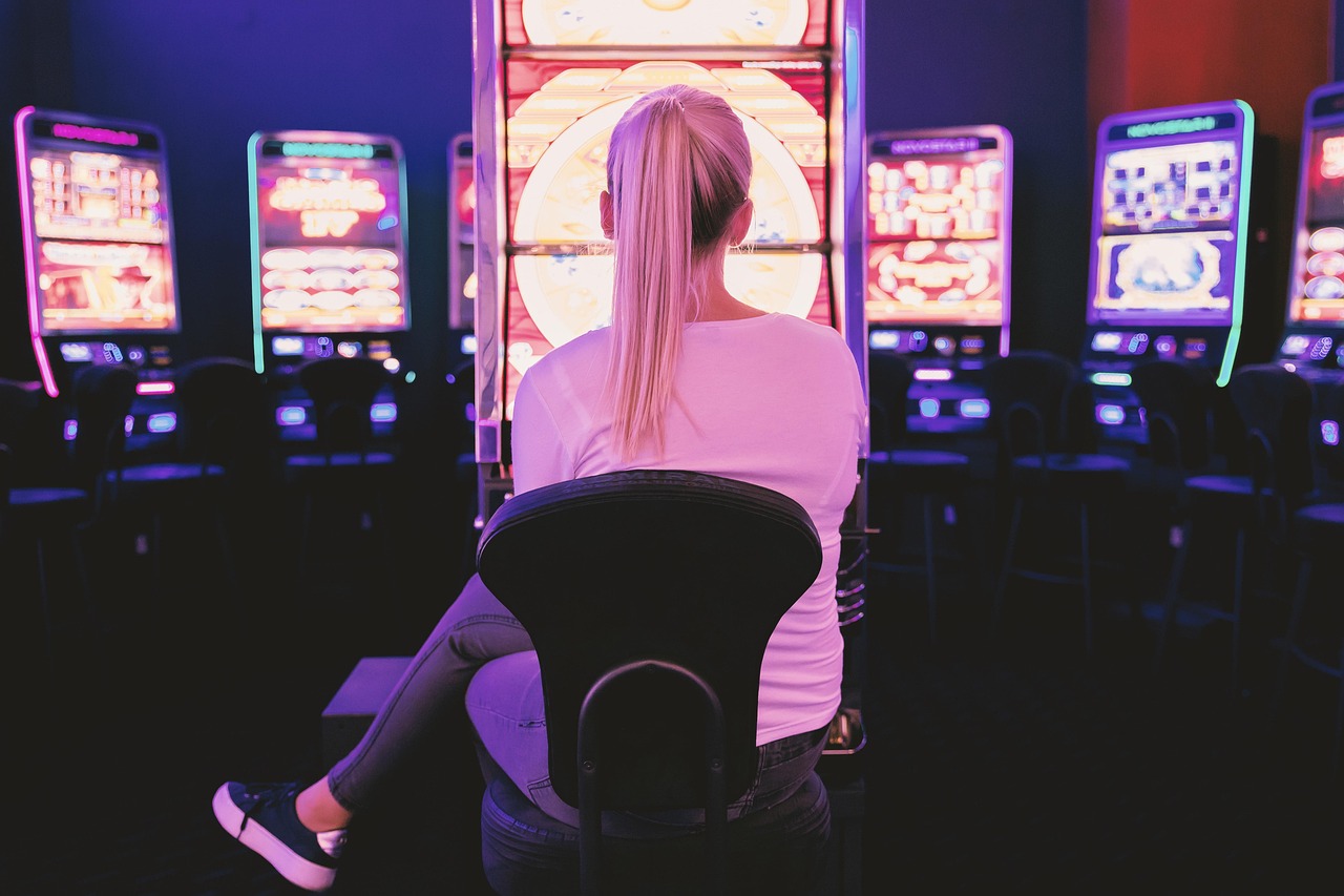 Young woman playing on a casino slot machine