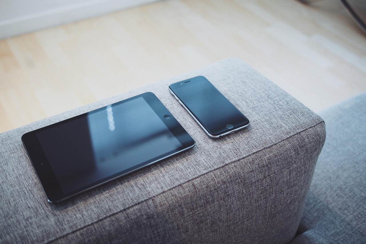 Apple tablet and iPhone devices side by side